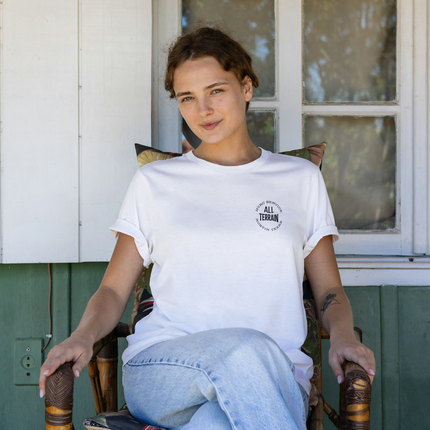 Person wearing a white t-shirt with a logo, sitting on a chair outdoors. Person wearing a white t-shirt with text and a graphic on the back, standing on a city street. Men women unisex sized Funny tshirt, fun t shirt, when the ladies get hot, when the ladies got hot, they call me, all terrain HVAC jokes, HVAC contractor shirts