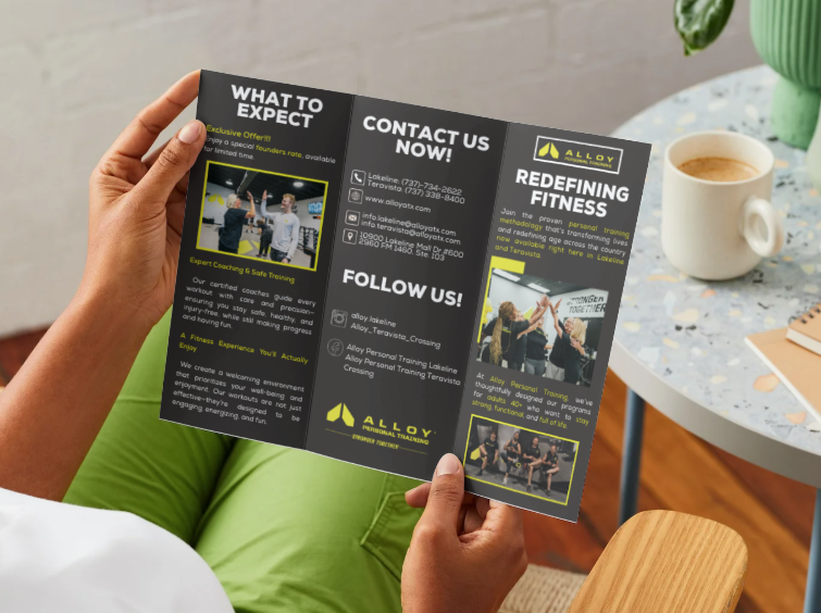 Person holding a brochure with 'Alloy' branding and fitness-related content. tri fold business promotion flyer brochure 